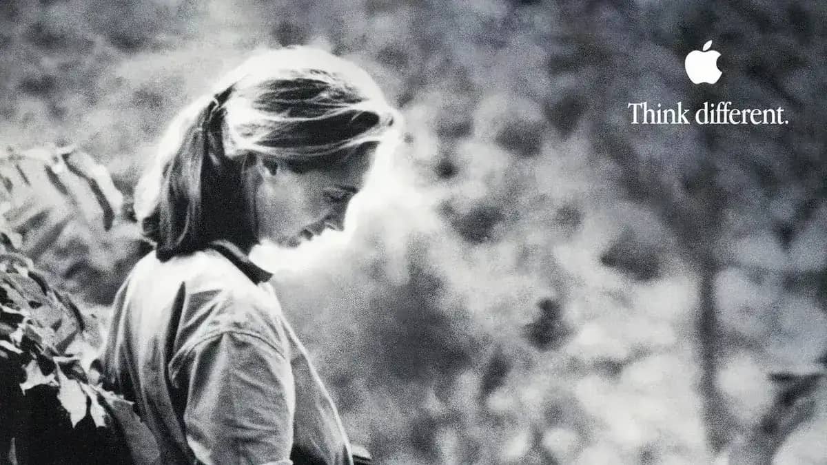 Black-and-white Apple "Think different" campaign image of a woman in profile looking down outdoors, with the Apple logo and slogan in the corner