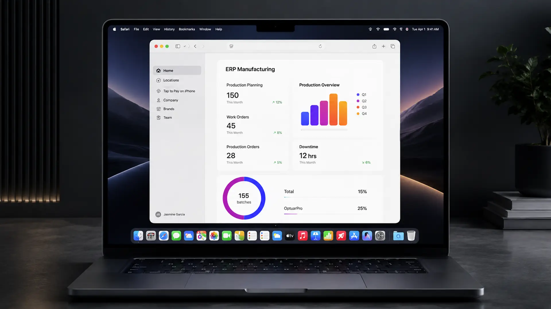 A laptop on a dark desk showing an ERP manufacturing dashboard with production planning counts, a quarterly bar chart, and a batch completion ring