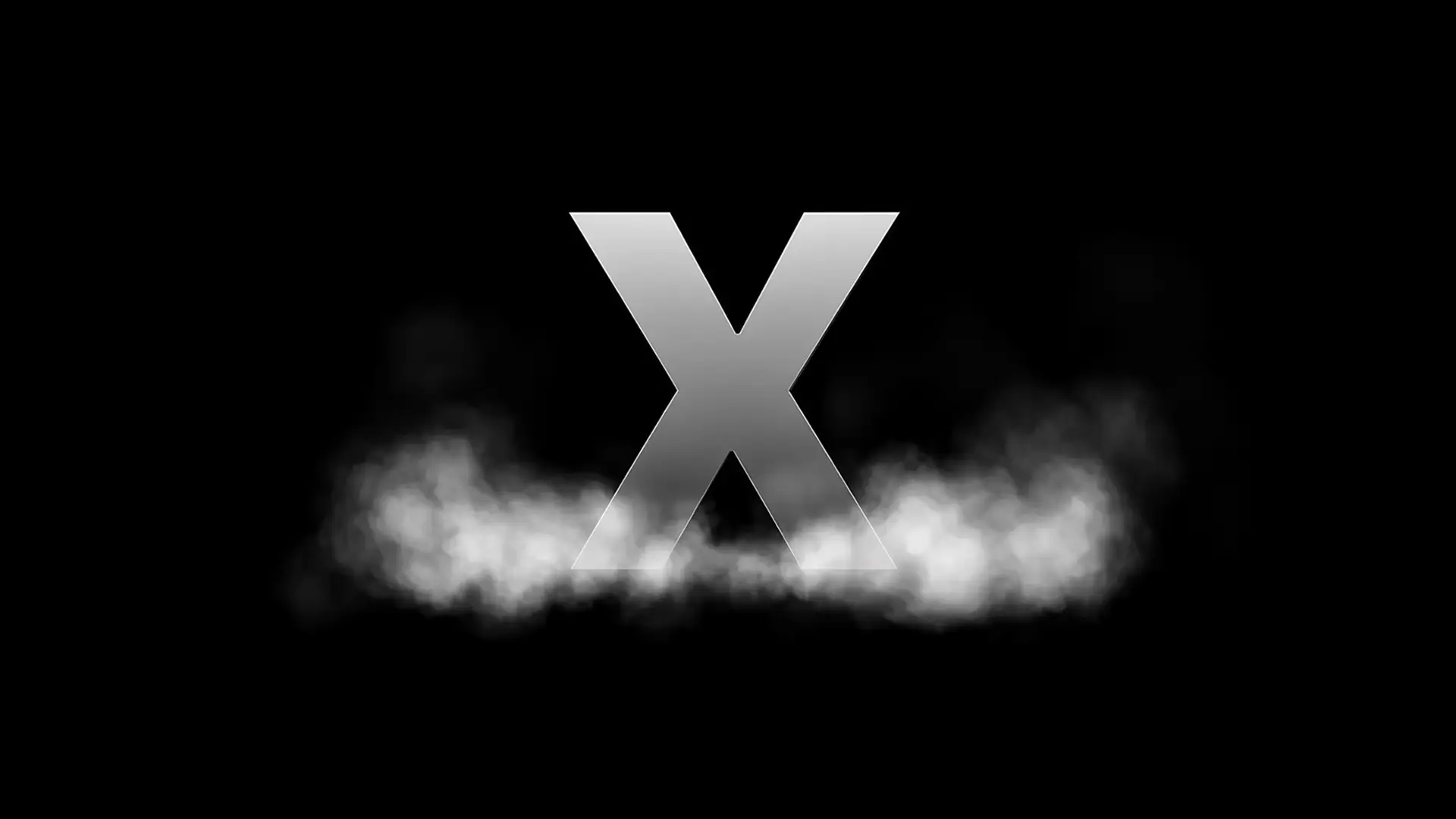 A polished metal letter X standing in low drifting fog against a black field